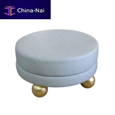 Contemporary ottoman MONTAIGNE fabricwood with gold leaf finishround