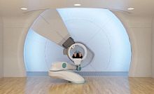 Proton therapy cyclotron with robotized positioning table SC360with integrated CT scannerwith integrated PET scanner